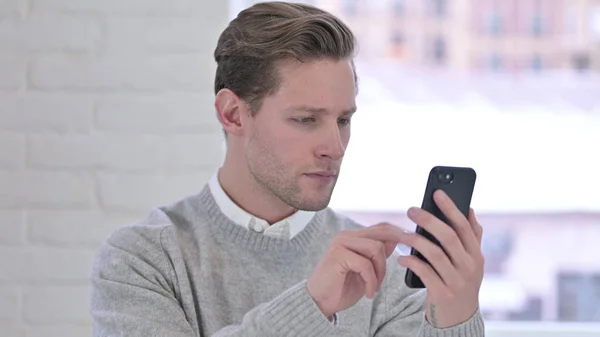 Portrait of Relaxed Creative Young Man using Smartphone — Stock Photo, Image