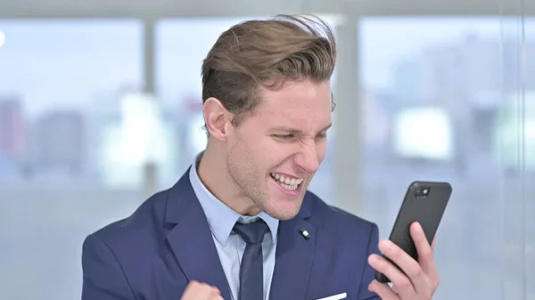 Portrait of Sad Young Businessman getting Loss on Smartphone — Stock Photo, Image