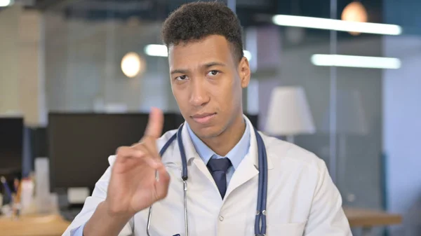 Portrait of Young Doctor saying No with Finger Sign
