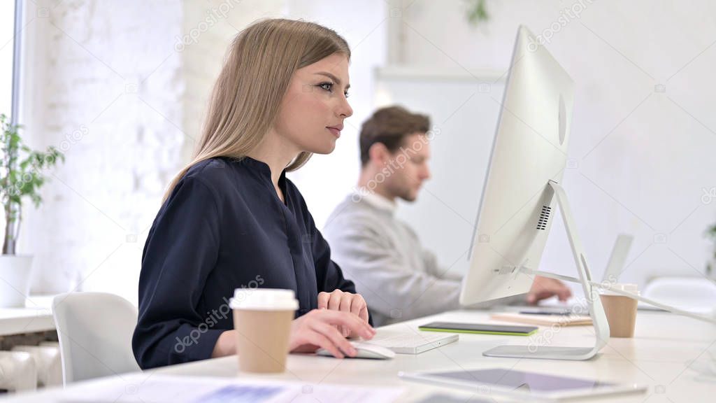 Creative Woman Working on Desktop in Modern Office