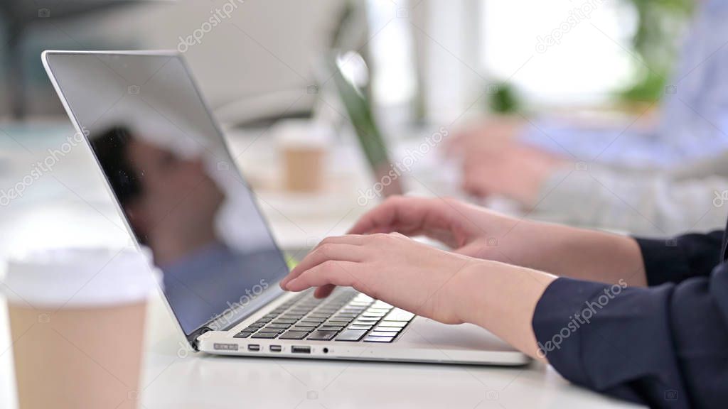 Close Up of Young Woman Working Laptops in Office