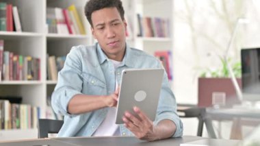 Creative Young African American Man using Digital Tablet 