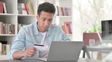 Online Shopping by Young African American Man, Using Credit Card for Payment