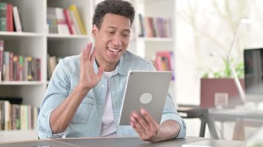 Online Video Chat on Tablet by Young African American Man at Work 