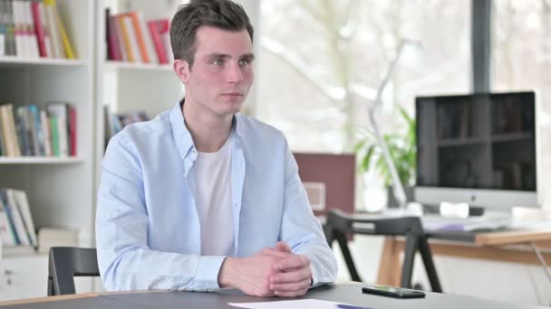 Serious Young Man in Office Looking at Camera — Stock Video