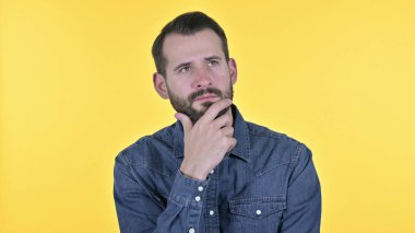 Portrait of Young Man Thinking about Idea, Yellow Background