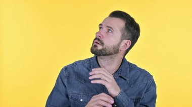 Confused Scared Young Man Looking Side Ways, Yellow Background