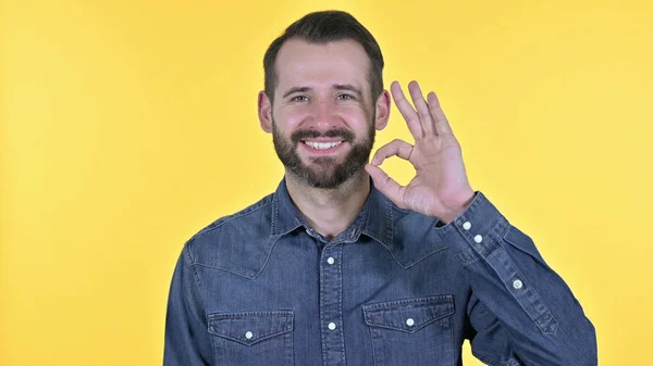 Portret van Vrolijke jongeman doet OK Sign, Gele achtergrond — Stockfoto