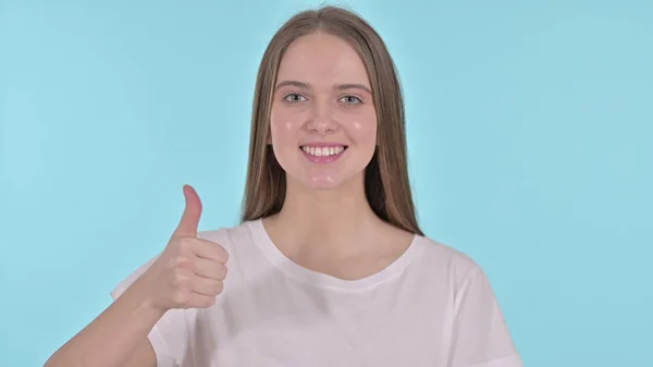 Thumbs Up by Cheerful Beautiful Young Woman, Blue Background — Stok Foto