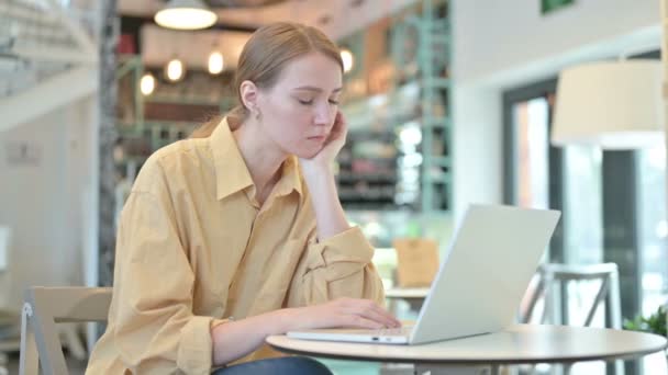 Ung kvinna med laptop tar en tupplur i Café — Stockvideo