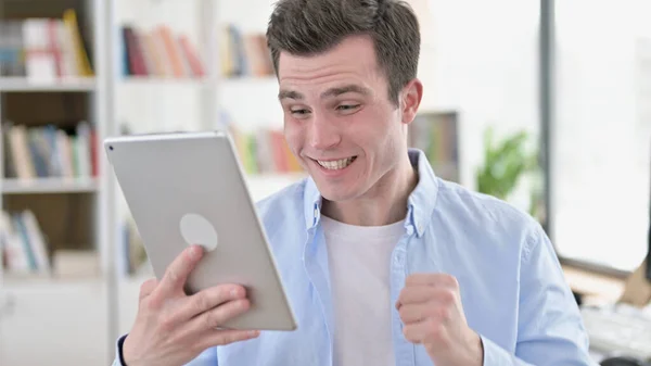 Young Man Celebrating Success on Tablet PC — Stock Photo, Image