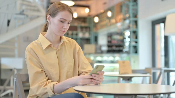 Mujer joven seria usando Smartphone en Café — Foto de Stock
