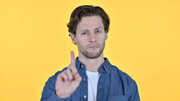 No Gesture by Young Man, Znak palca na żółtym tle — Zdjęcie stockowe