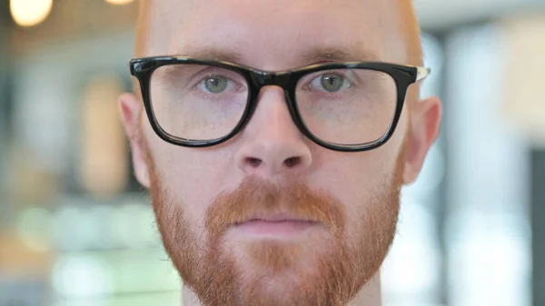 Close up of Serious Face of Young Redhead Man