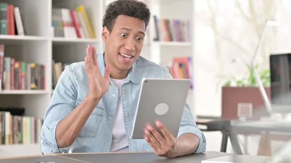 Online Video Chat on Tablet by Young African American Man at Work — Stockfoto