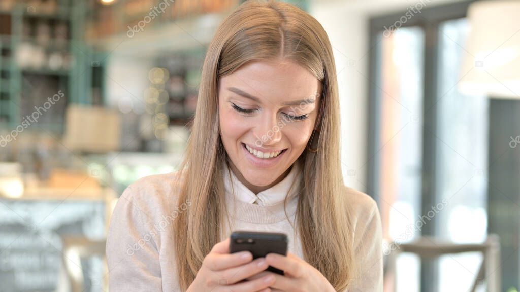 Portrait of Happy Young Woman using Smartphone