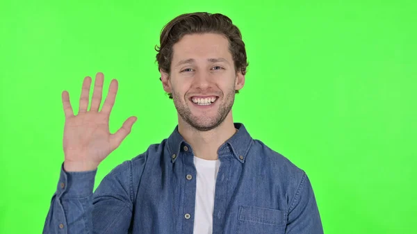 Hello, Young Man Waving and Cheering at the Camera on Green Chroma Key — 图库照片