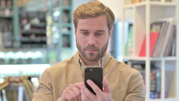 Portrait of Young Man using Smartphone — Stock Video