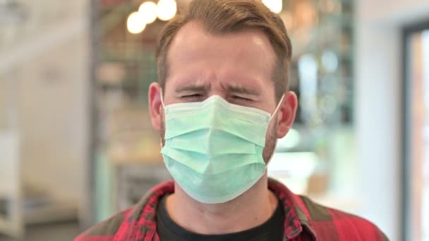 Portrait of Young Man with Face Mask having Headache — Stock Video