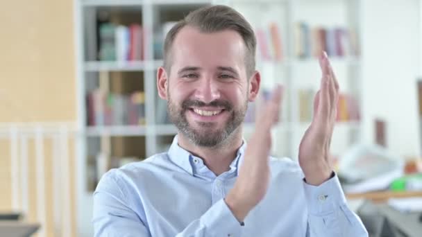 Porträt eines fröhlichen jungen Mannes, der klatscht und applaudiert — Stockvideo