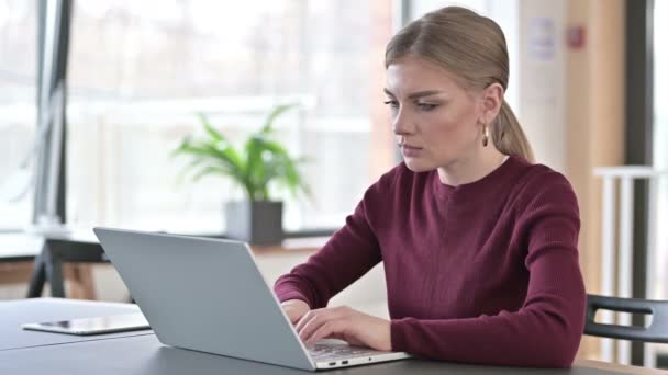 Mladá žena slaví úspěch na notebooku v kanceláři — Stock video