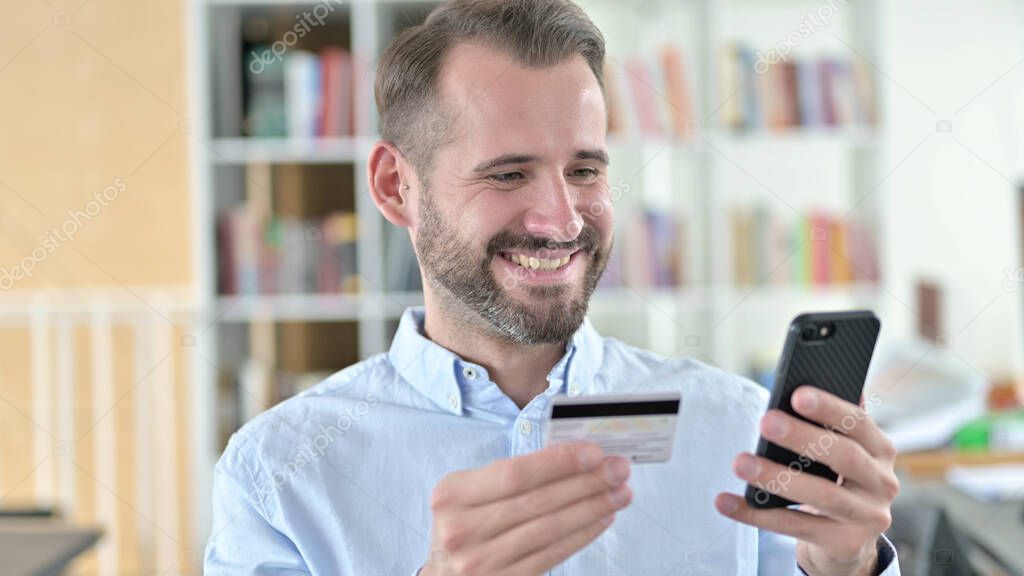 Portrait of Online Payment Success on Smartphone by Man