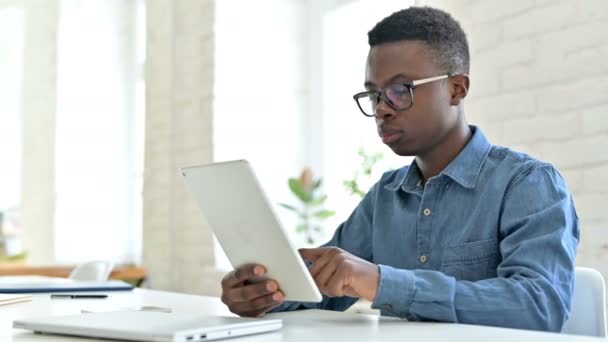 Sukces, młody Afrykanin świętuje na tablecie w biurze — Wideo stockowe