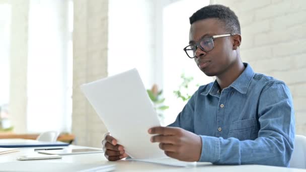 Upset Young African Man having Loss on Documents in Office — Stock Video