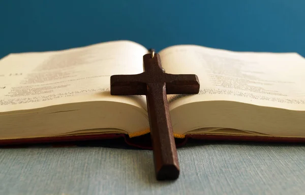 Деревянный крест на открытой библии — стоковое фото