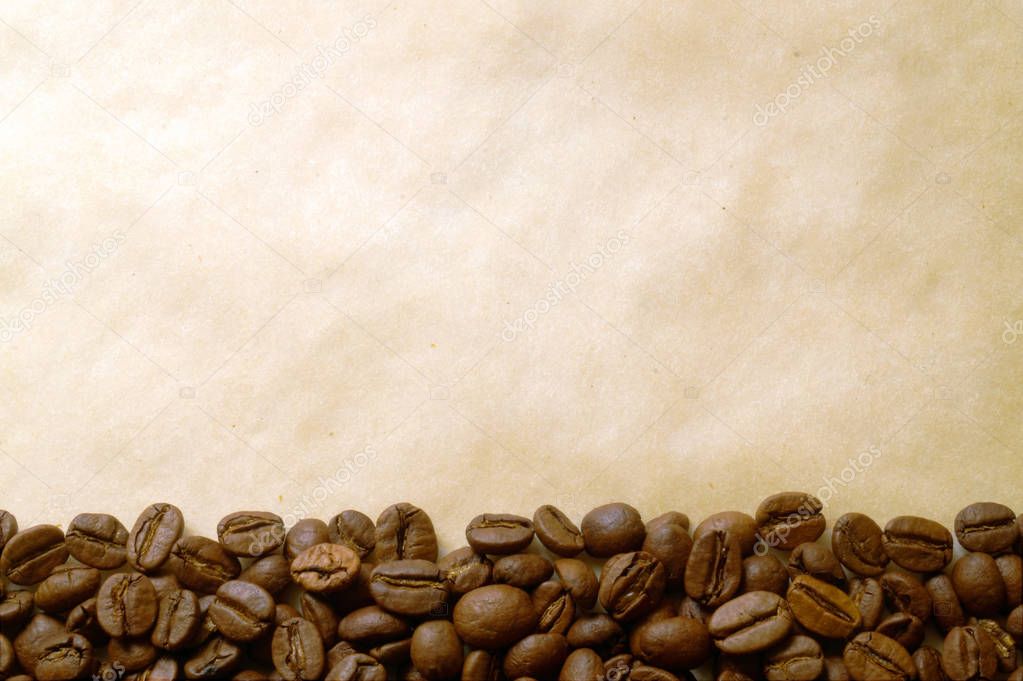 Coffee beans on old burnt paper background