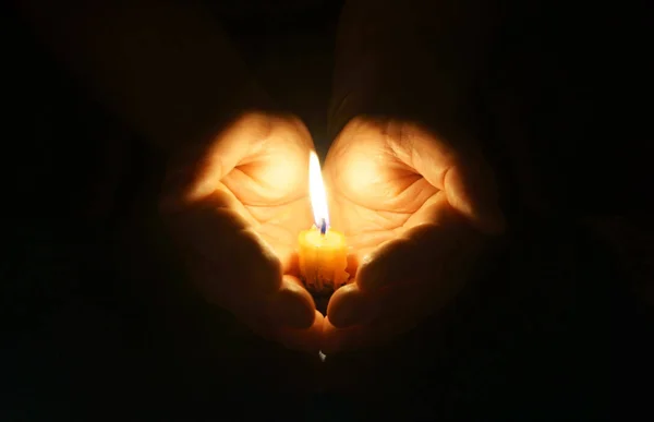 Cupped hands with burning candle. — Stok Foto