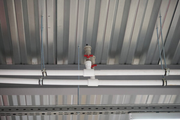 fixing the pipes under the ceiling