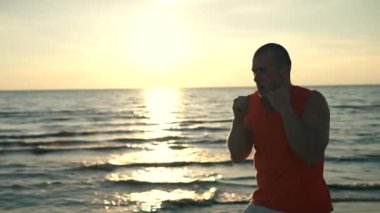 gün batımında sahilde boks adam uygun