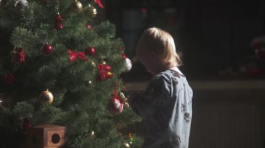 Küçük bir çocuk bir Noel ağacı süsleme