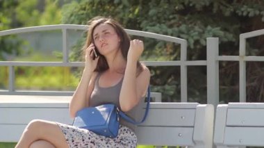 Güzel esmer kız telefonda konuşuyor.