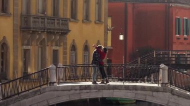 Çift Venedik'te bir köprüde öpüşme