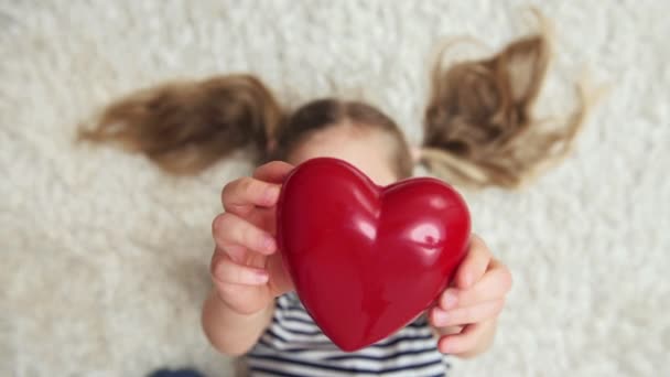 Улыбающаяся Девушка Красным Сердцем Лежащая Полу Понятие Любви Счастья — стоковое видео