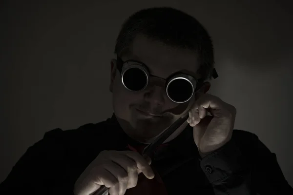 A robber with a knife. In safety glasses. A knife at the level of the head. Crime. — Stock Photo, Image