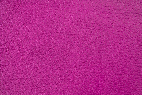 Background or backdrop of artificial leather. Pink color scale.