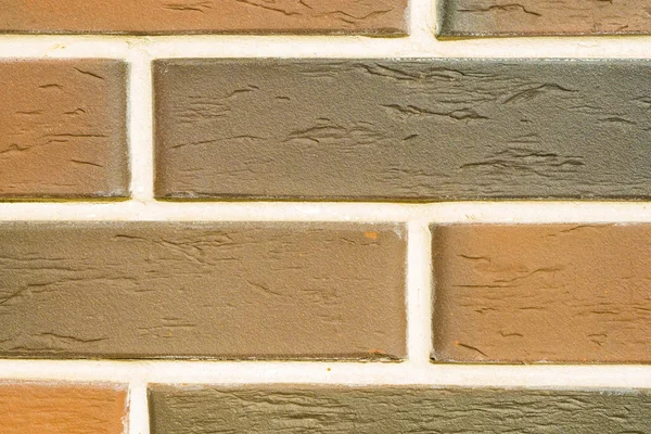 A brick level background. Texture or backdrop of decorative beige and brown stone. Clinker brick. — Stock Photo, Image