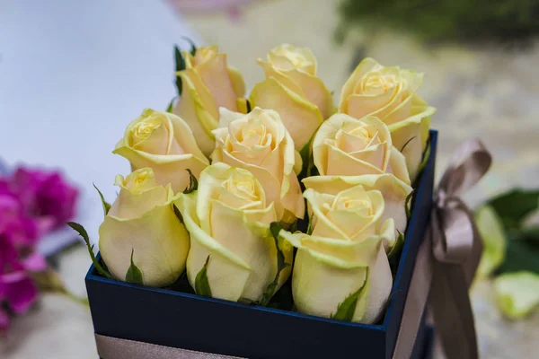 Yellow roses are packed in a box.