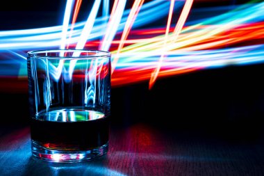 Bir bardak konyak ahşap bir masa üzerinde.