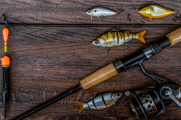 Fishing tackle still life on a wooden background.