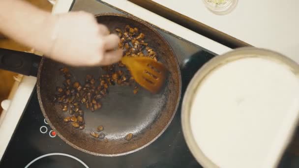 Koekenpan op een elektrisch fornuis. Paddestoelen zijn gebakken. — Stockvideo