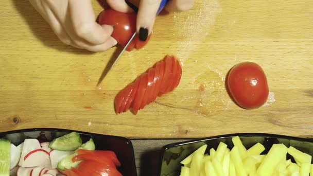 Closeup of human hands cooking vegetables salad in kitchen. — Stock Video