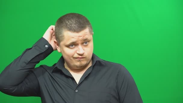 Young man posing. Thoughtfully. He scratched his head. Background green screen. — Stock Video
