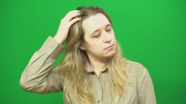 Sürpriz genç kadın saçlarını ucunda görünüyor. Yeşil arka plan.
