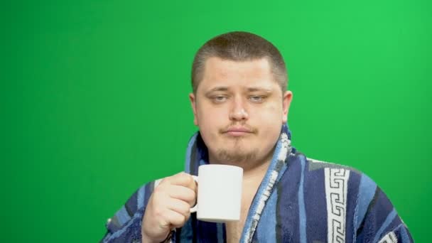 A fiatalember hoz létre. A reggeli kávét iszik. Álmos. — Stock videók