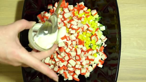 Preparation of salad with crab sticks. Add Mayo. Stir all the ingredients. — Stock Video