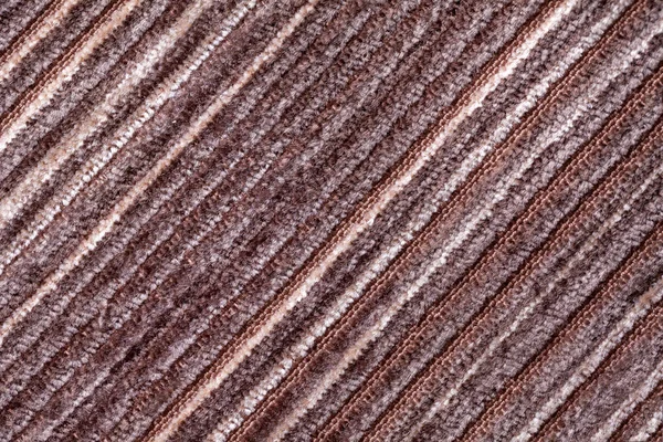 Bruine achtergrond van een gebreide textielstoffen. Stof met een gestreepte textuur-closeup. — Stockfoto